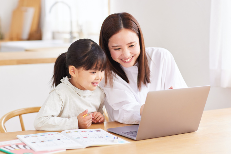 A parent and child looking at a tablet together